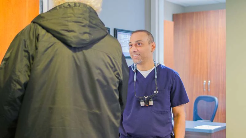 Dr. Prajapati talking with a patient at Midtown Dental