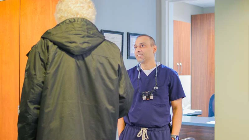 Dr. Prajapati discussing periodontal treatment with a patient