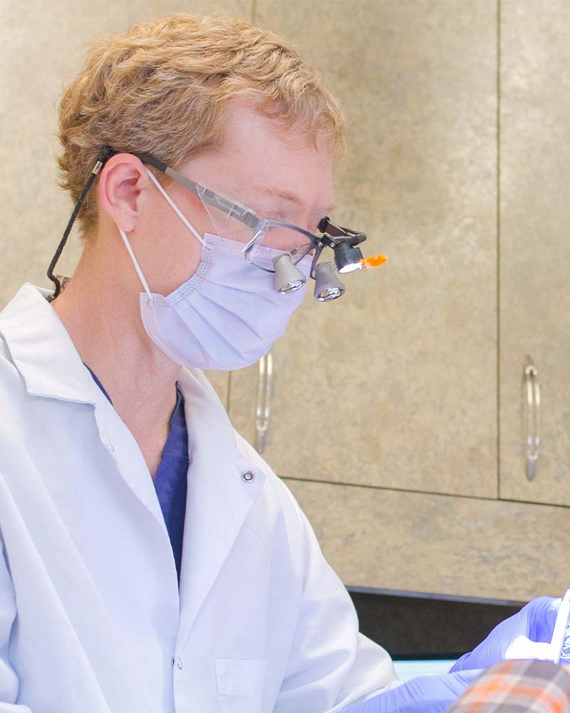 Dr. Rumley applying dental crowns